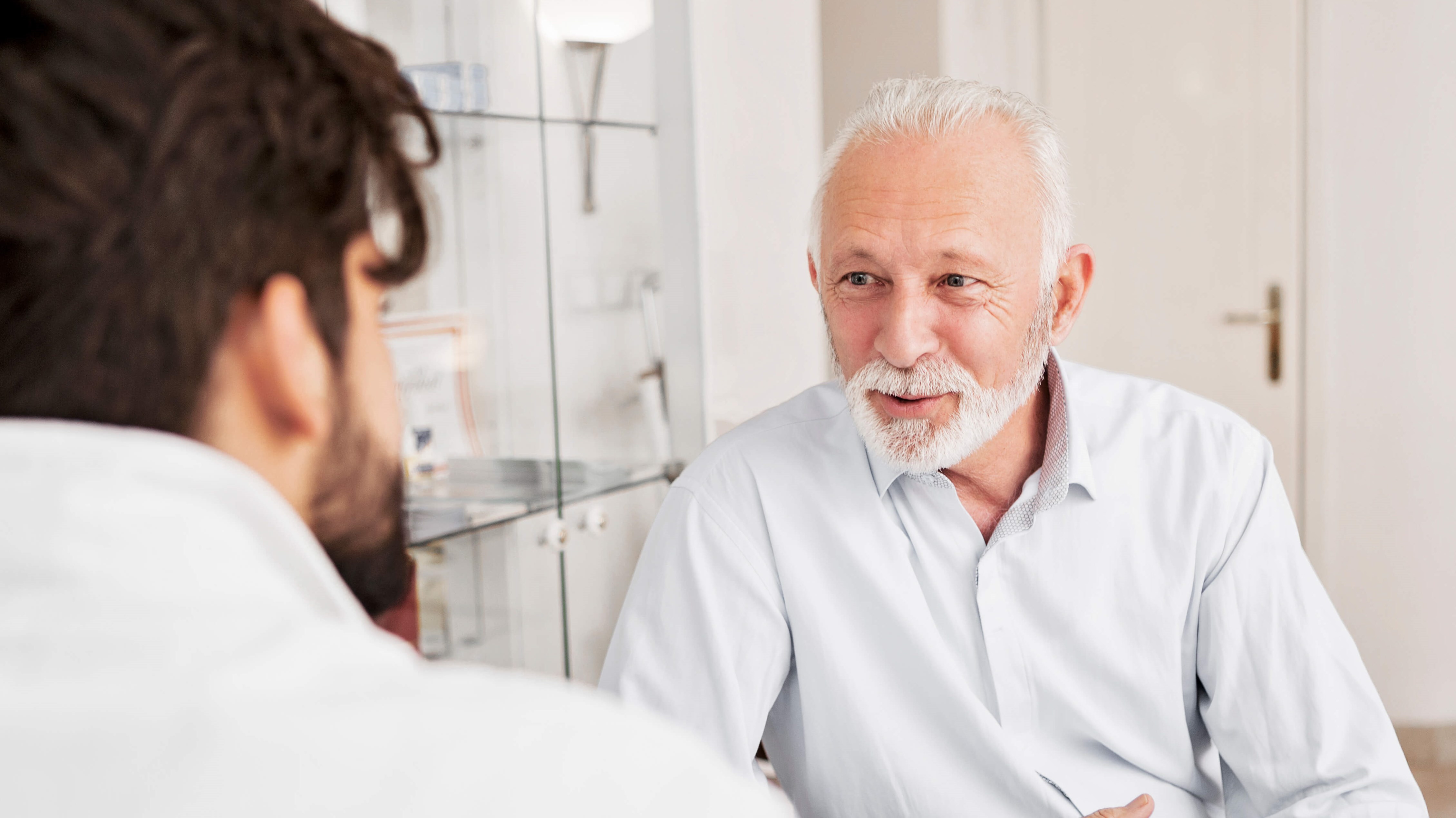 man speaking with doctor
